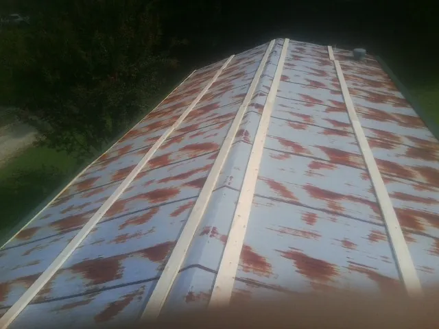 Rusted metal roof panels with new wood purlins before replacement — Storm Damage Roof Repair in Tigrett by Roofing Brothers