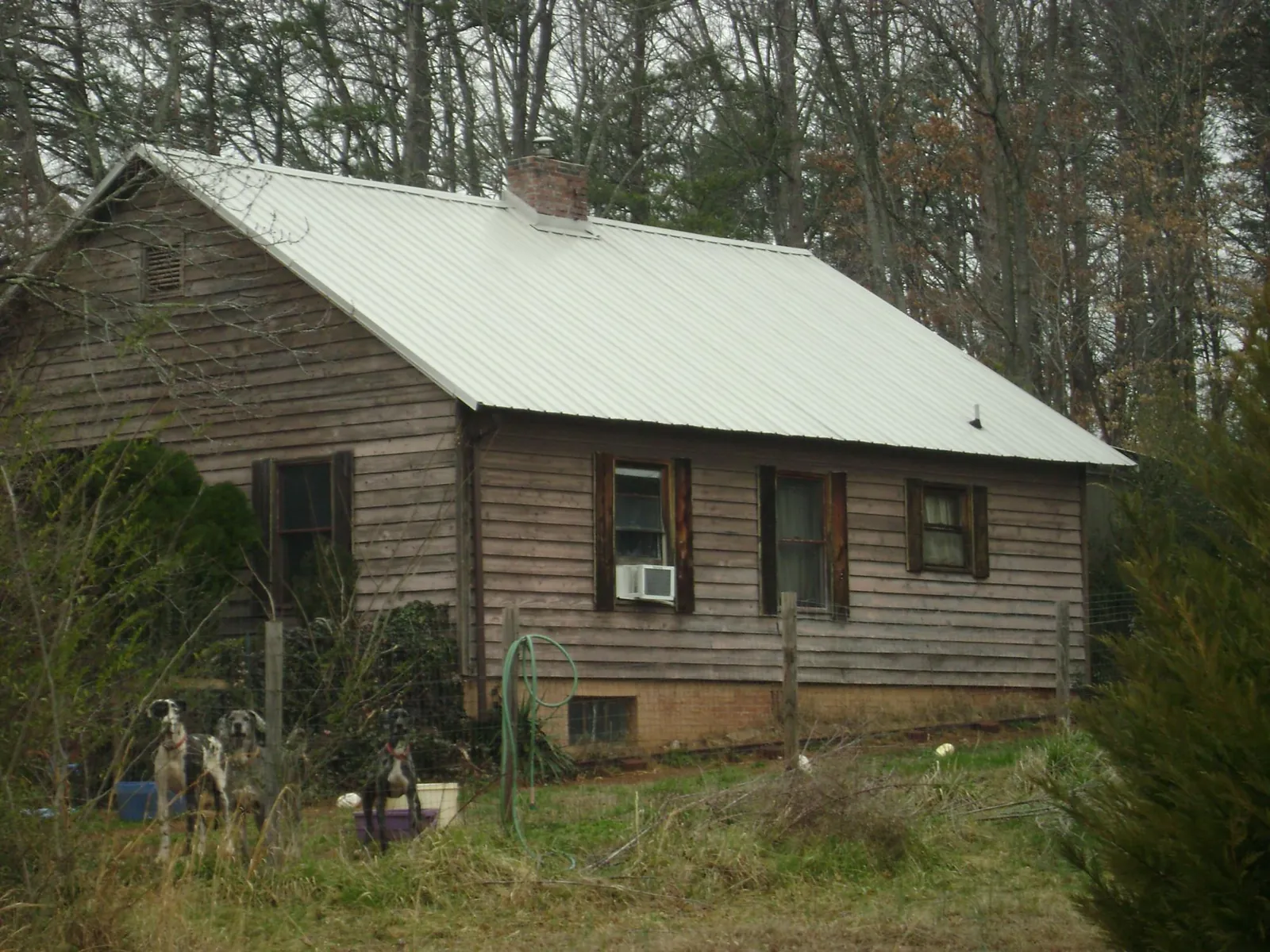 White metal roof on an old wood sided farmhouse, from a Metal Roof Installation job in Tigrett